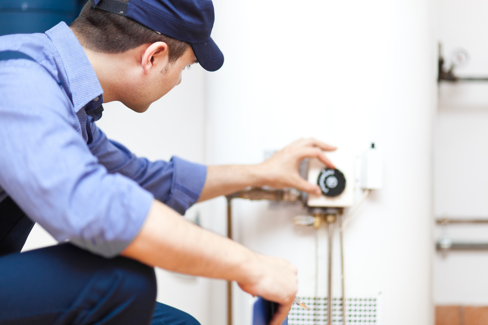 Plumber repairing a hot-water heater