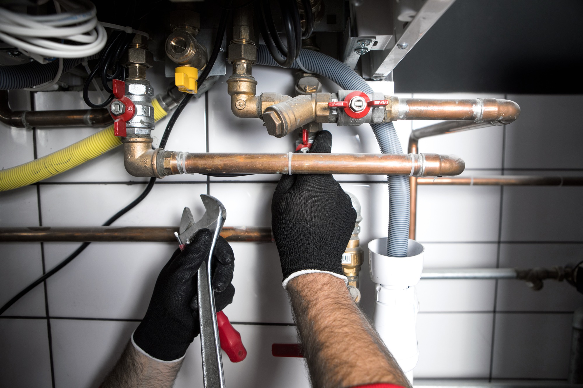 Technician servicing heating boiler